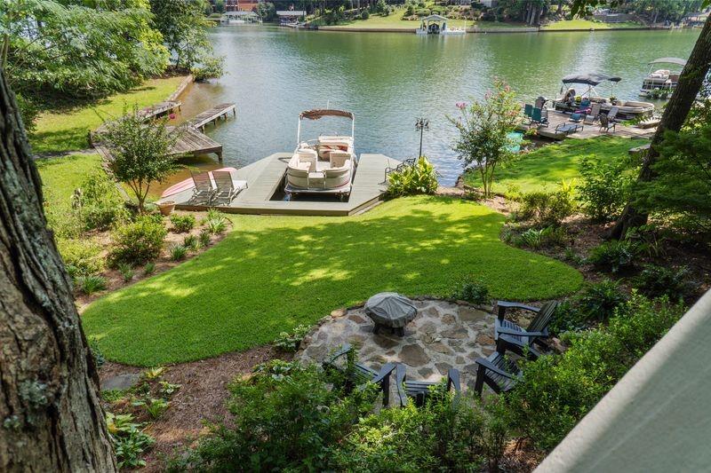 an aerial view of a house with garden space and a lake view