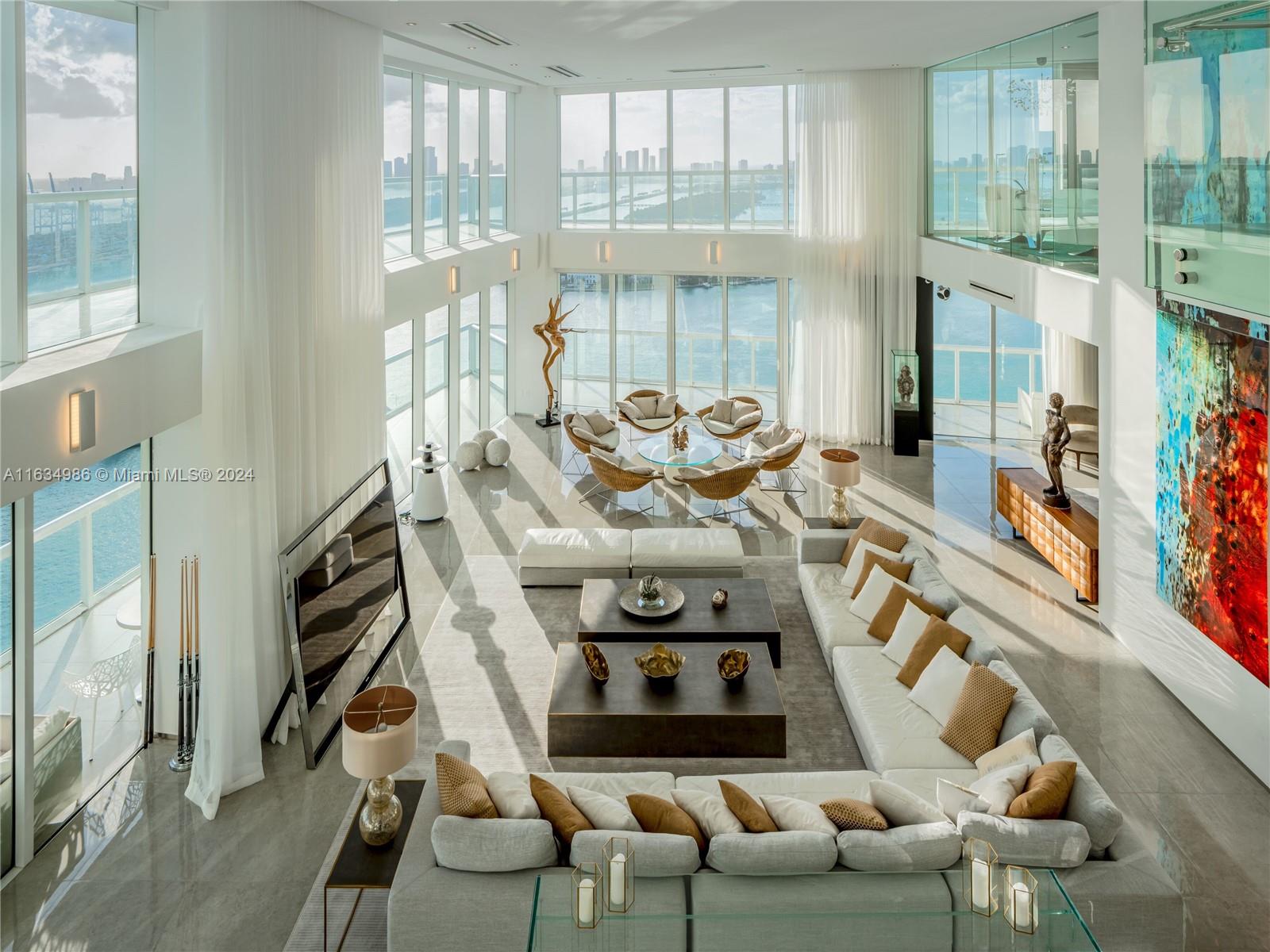 a view of a livingroom with furniture and floor to ceiling windows