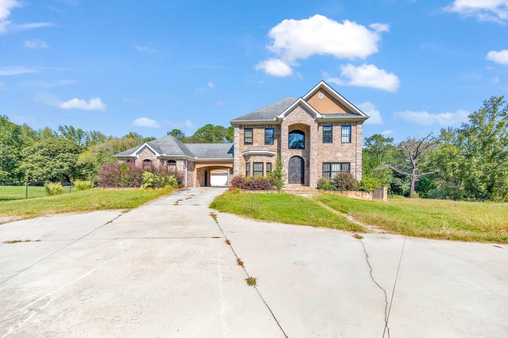 a front view of a house with a yard and garage