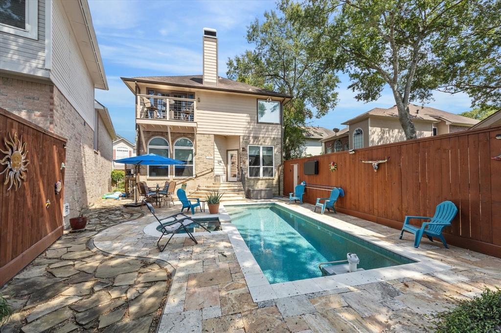 a backyard of a house with yard fire pit and outdoor seating