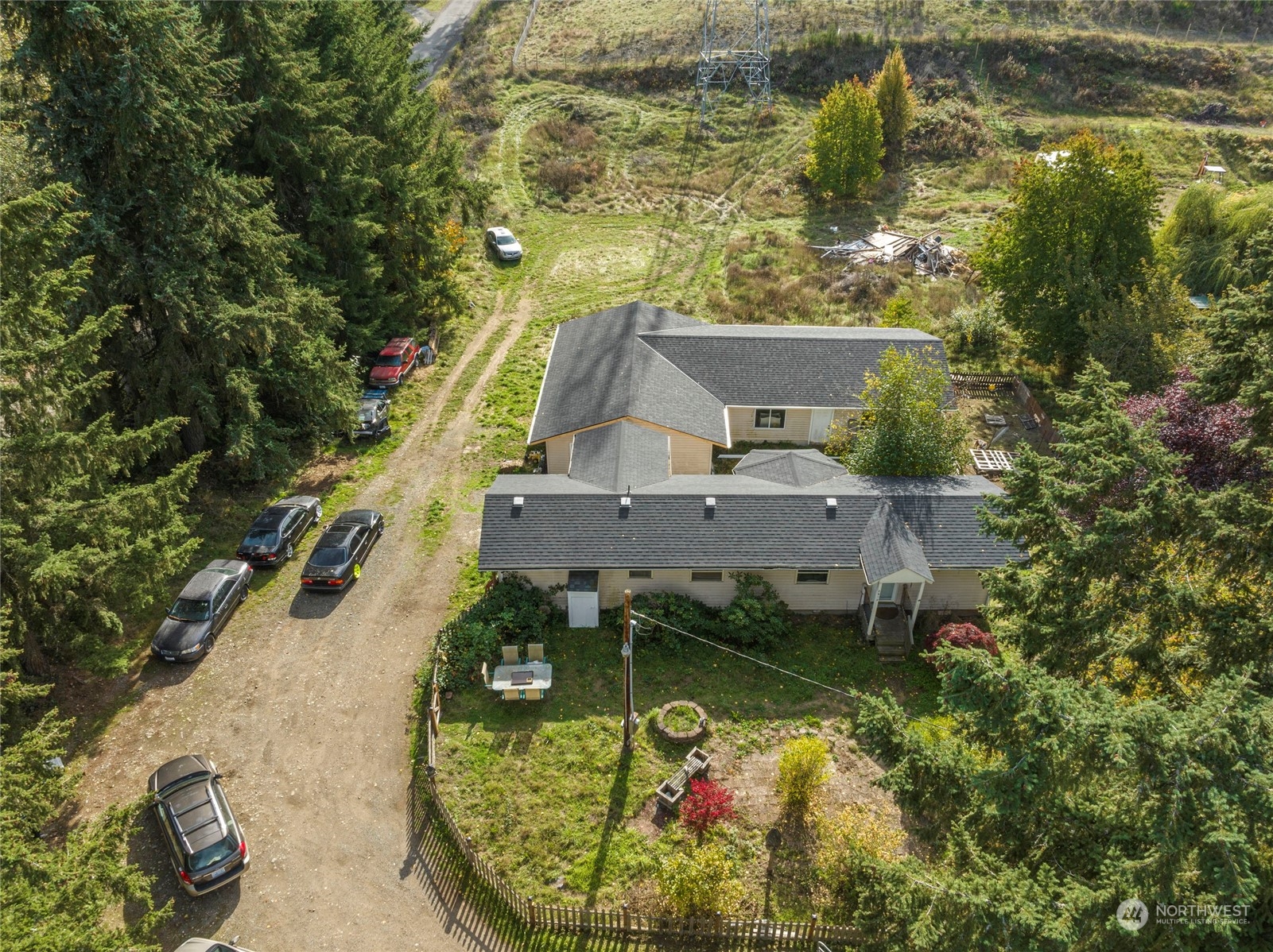 an aerial view of a house with a yard swimming pool and outdoor seating