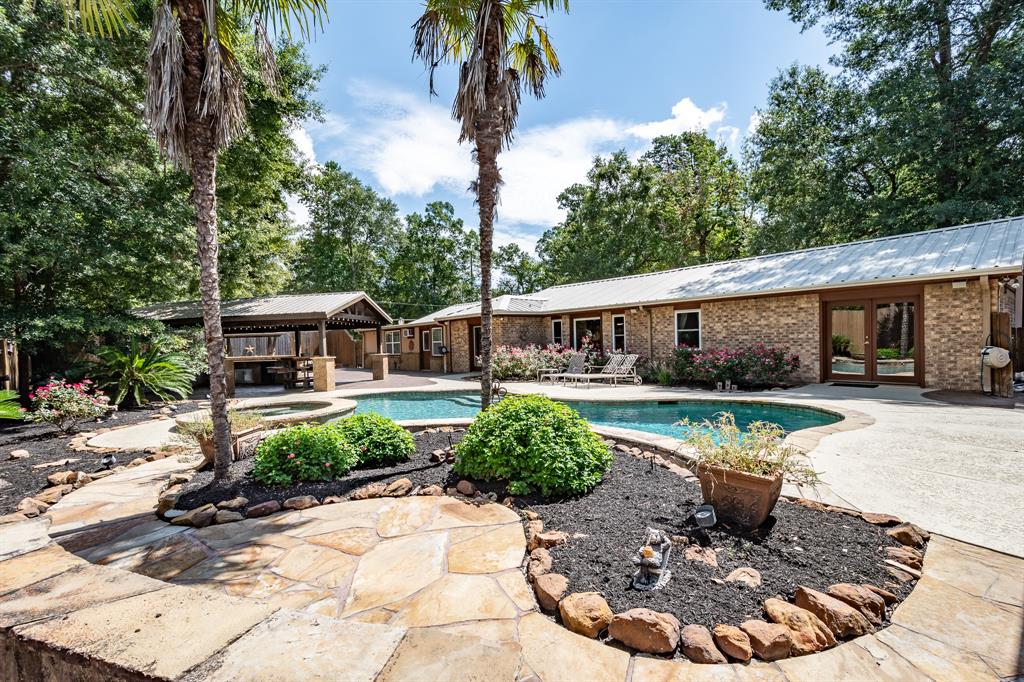 a view of a house with backyard tub and sitting area