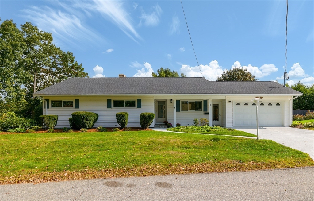 a front view of house with yard and outdoor seating