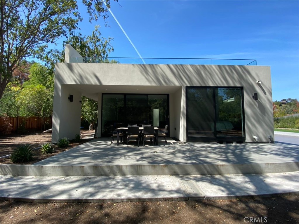 a view of a house with backyard outdoor seating area and garage