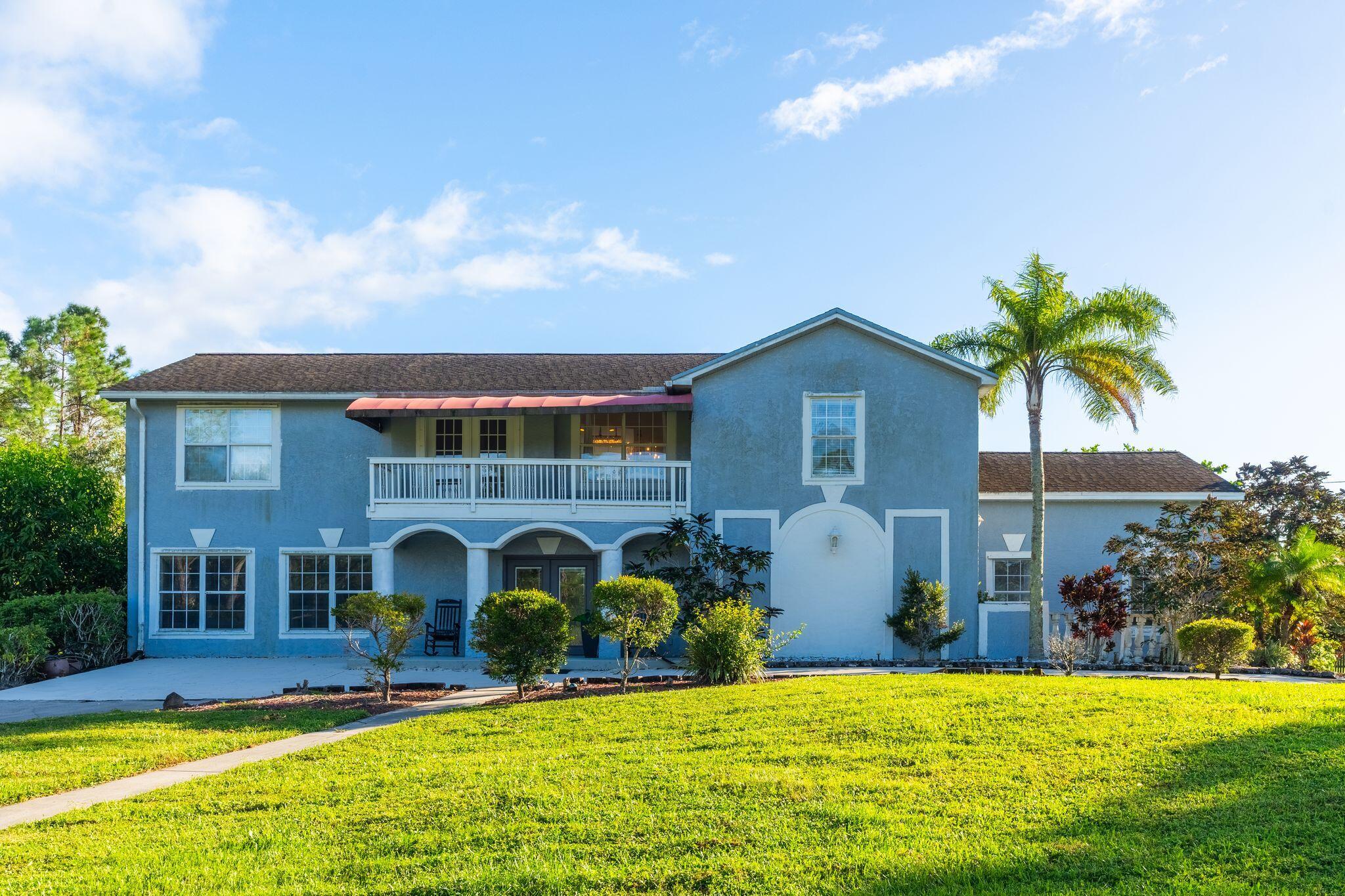 a view of an house with swimming pool and yard