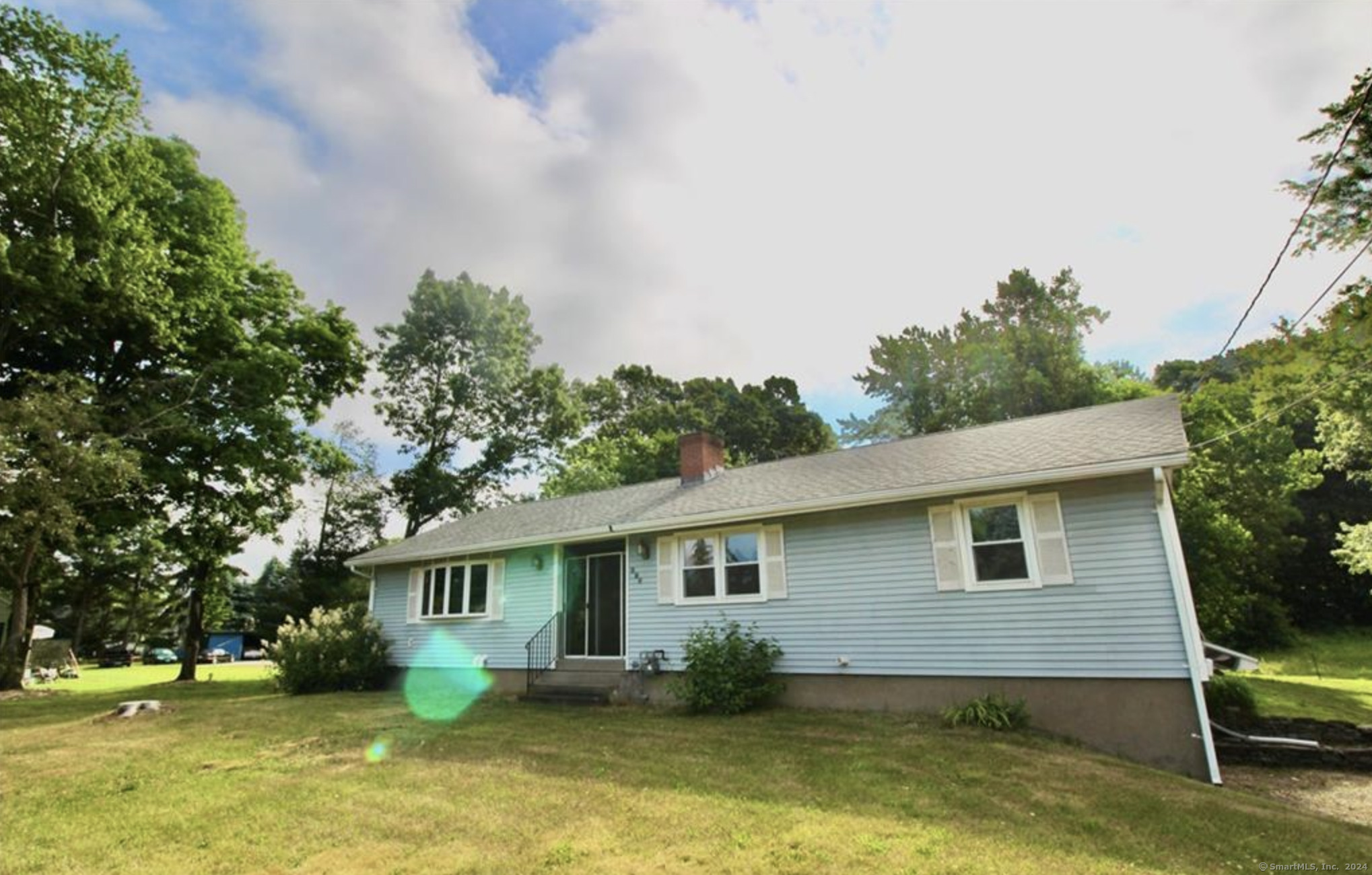 a view of house with a yard