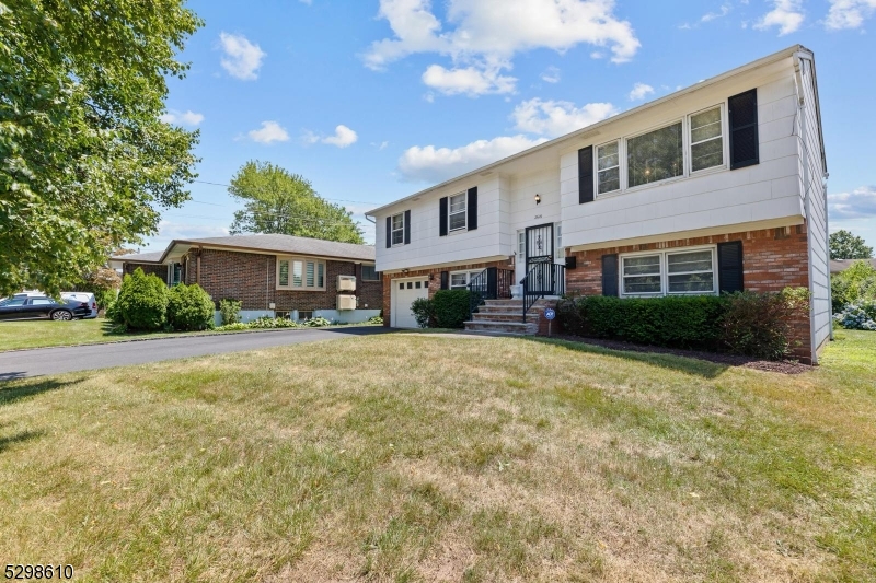 a front view of a house with a yard and outdoor seating