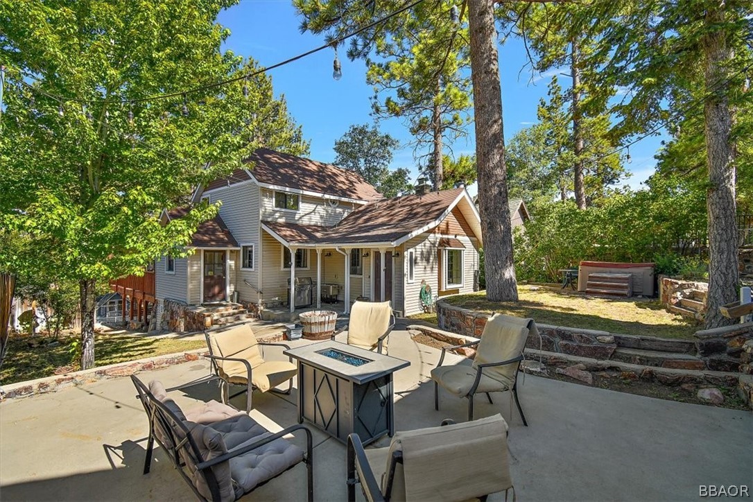 a view of a patio with table and chairs and floor to ceiling window