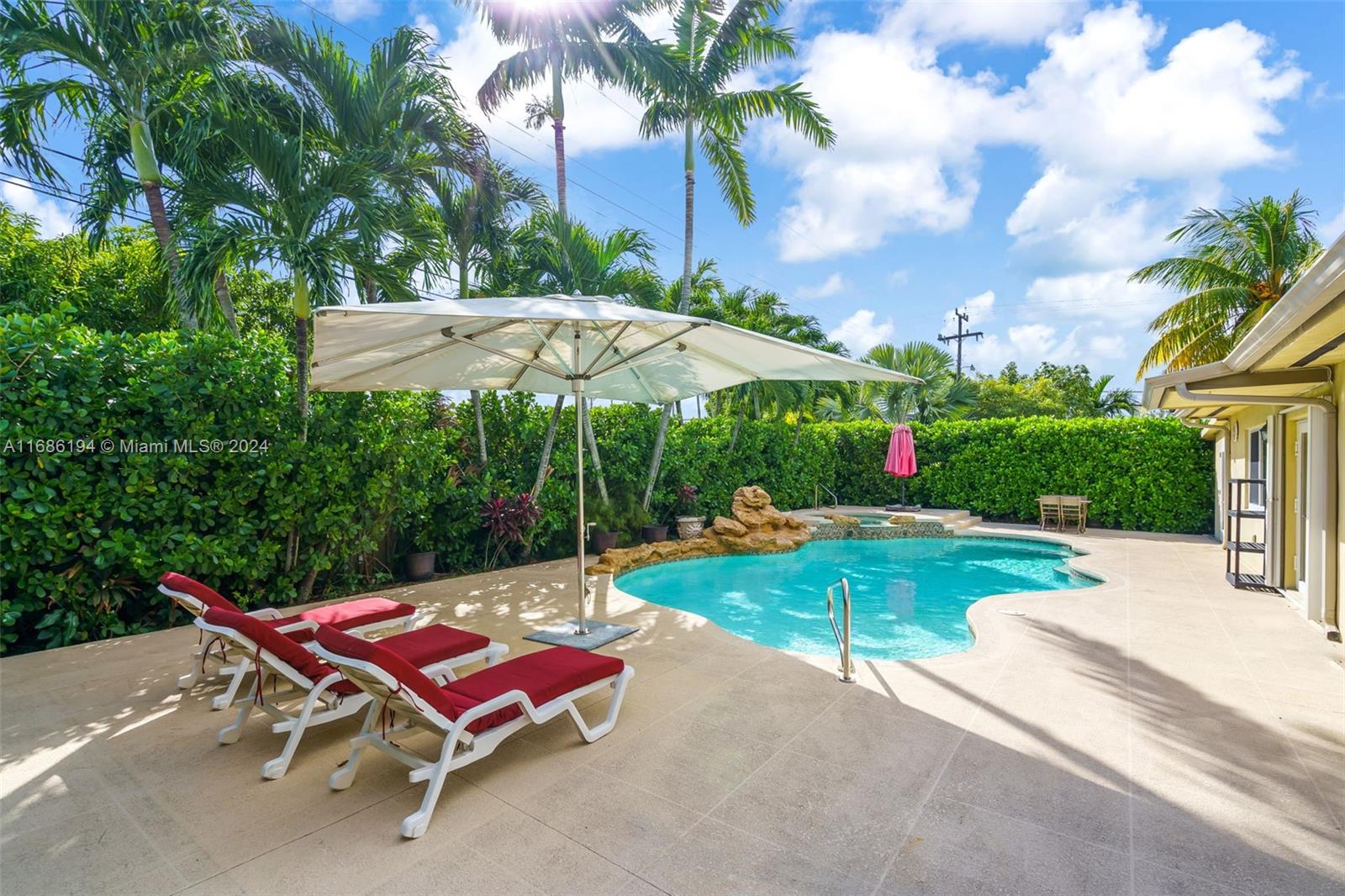 a view of a backyard with sitting area and garden