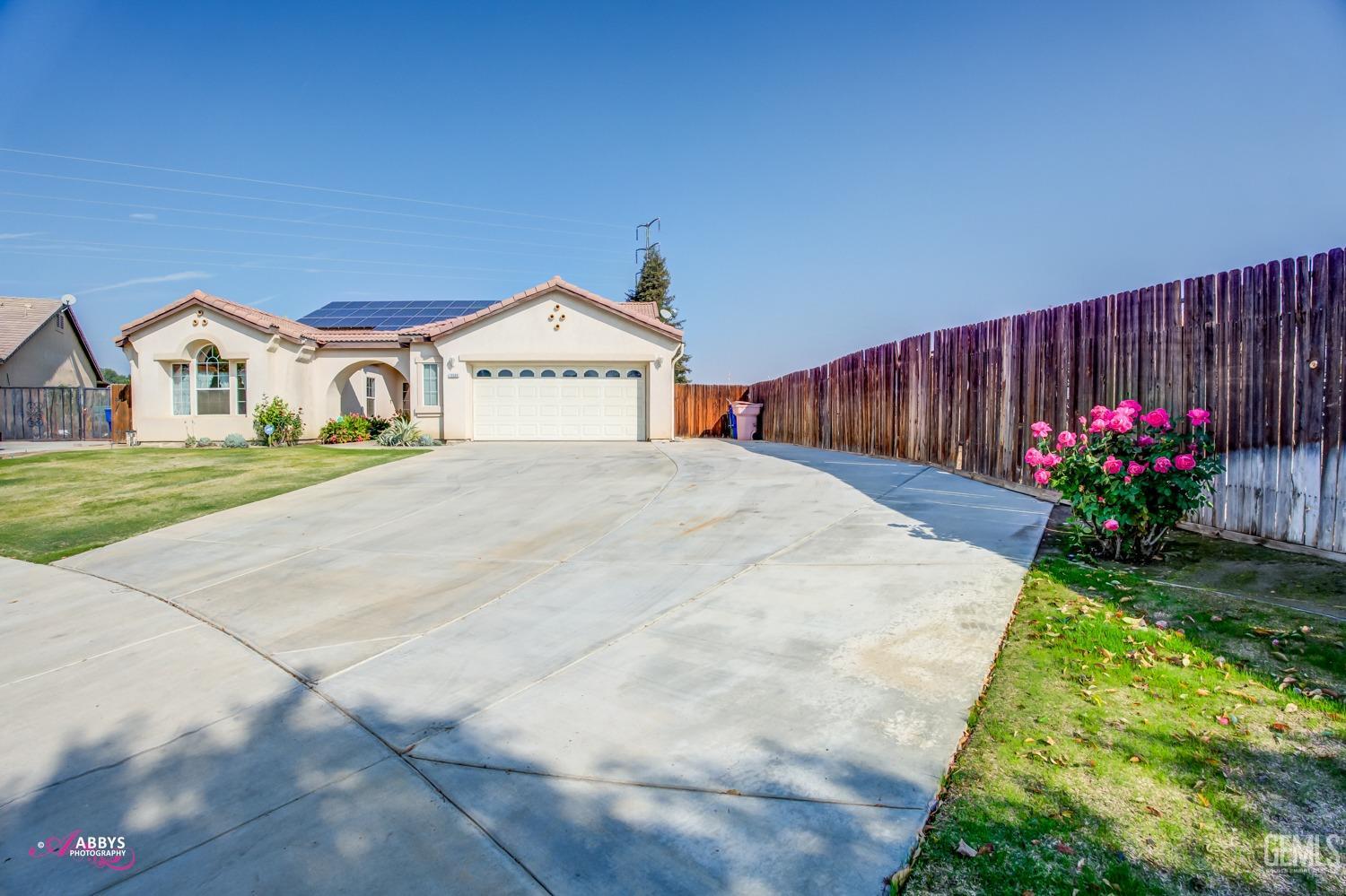 a view of a house with a yard and garden