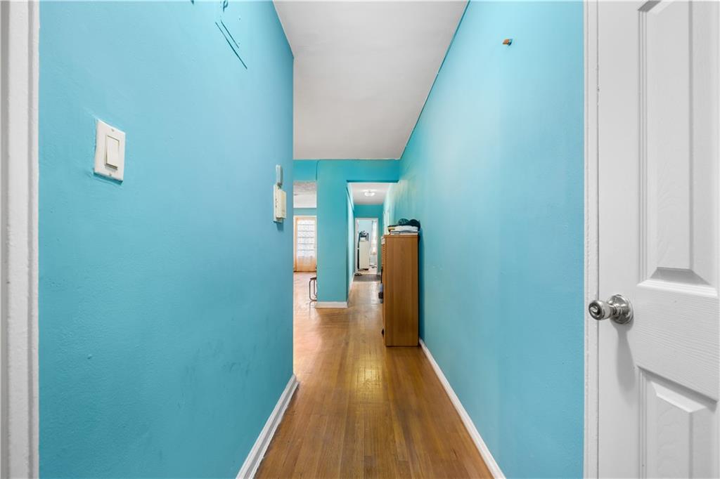 a view of a hallway with wooden floor