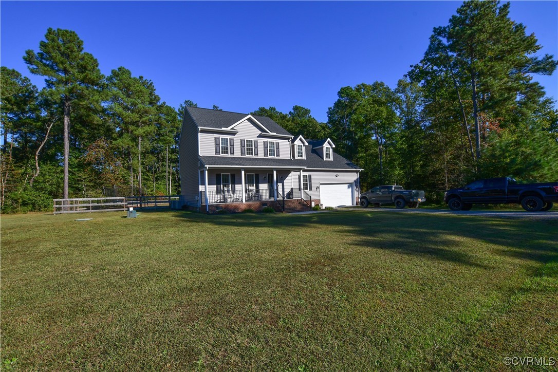 View of front of house with a front lawn and cover