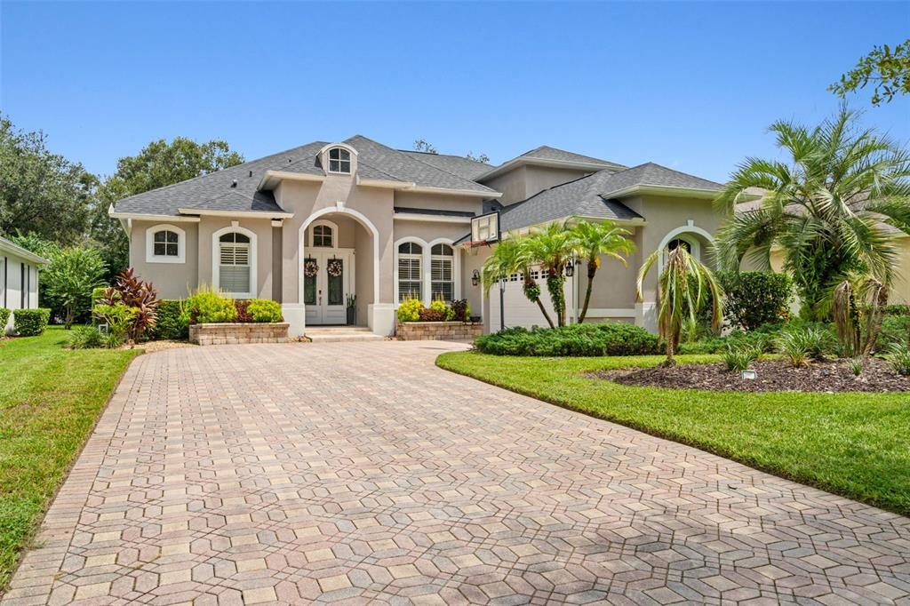 a front view of a house with yard and green space