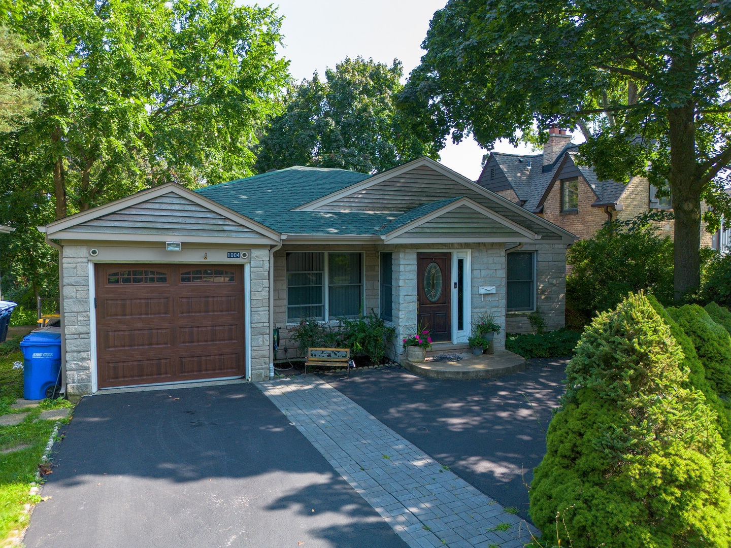 a front view of a house with a garden