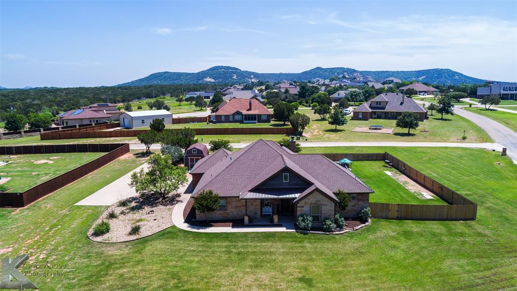 an aerial view of a house with garden space and mountain view