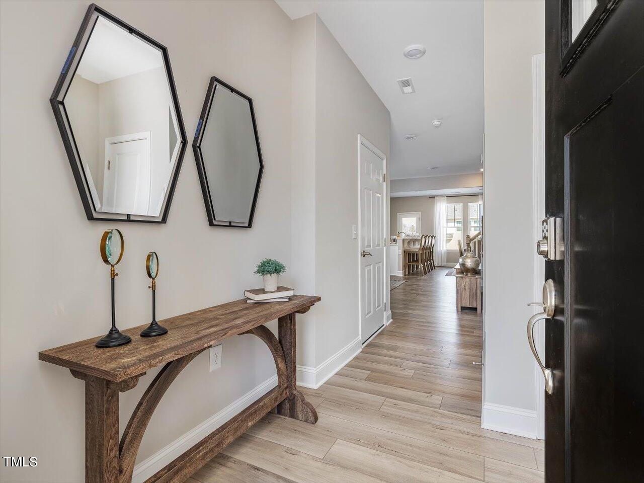 a view of a hallway with wooden floor and entryway