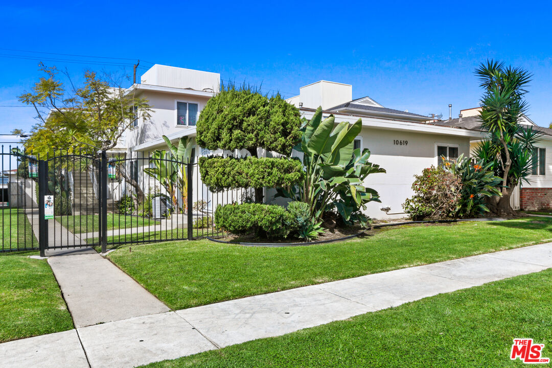 a view of a house with a yard and a garden