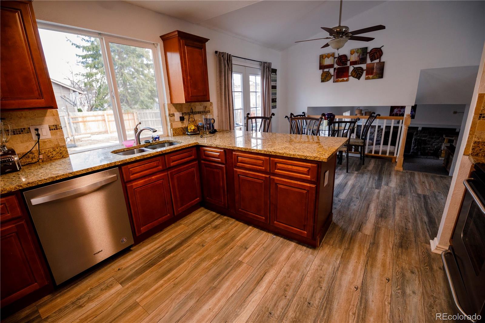 a kitchen with wooden floors and wooden cabinets