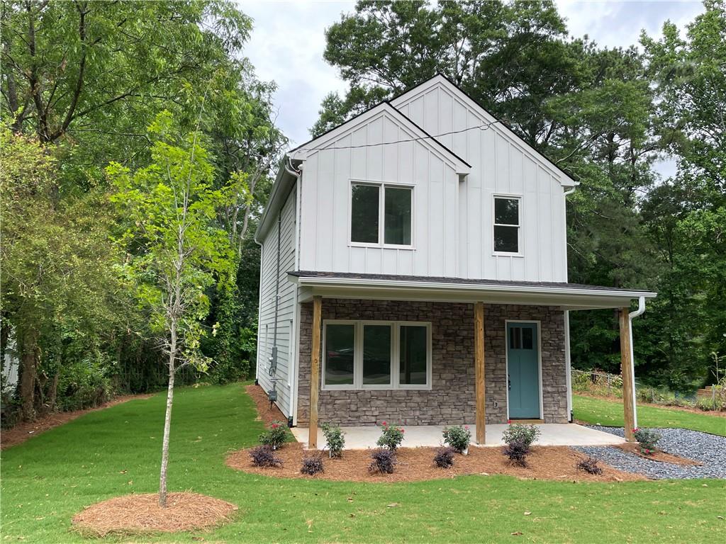 a front view of house with yard and green space