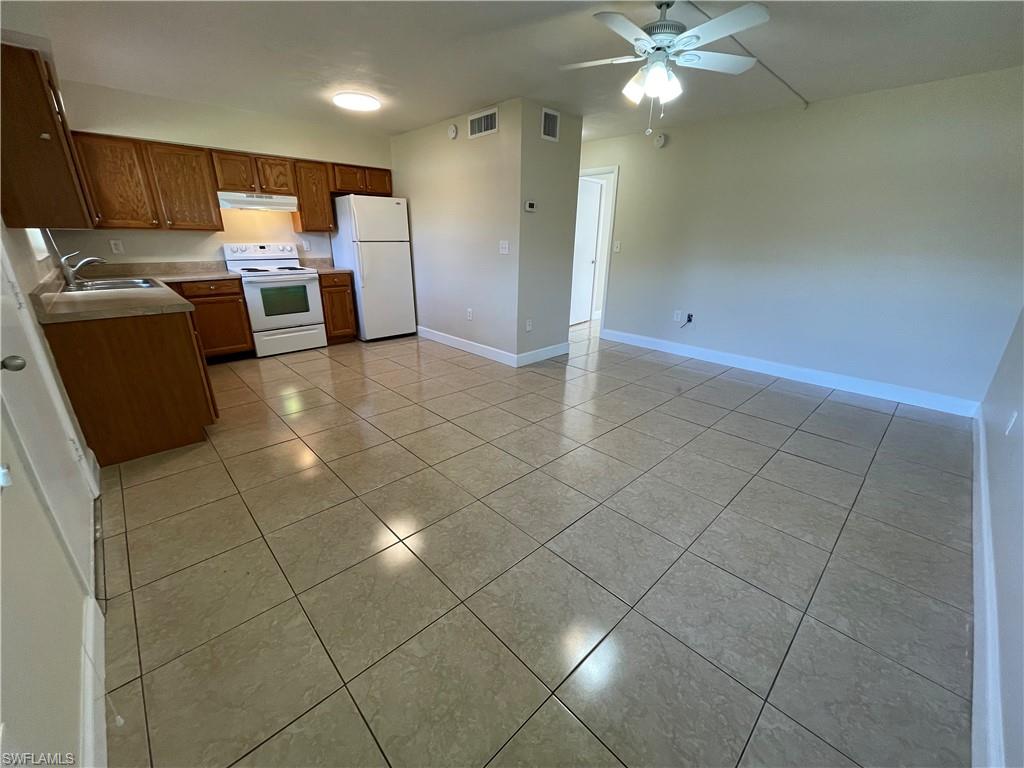 a kitchen with a sink cabinets and appliances