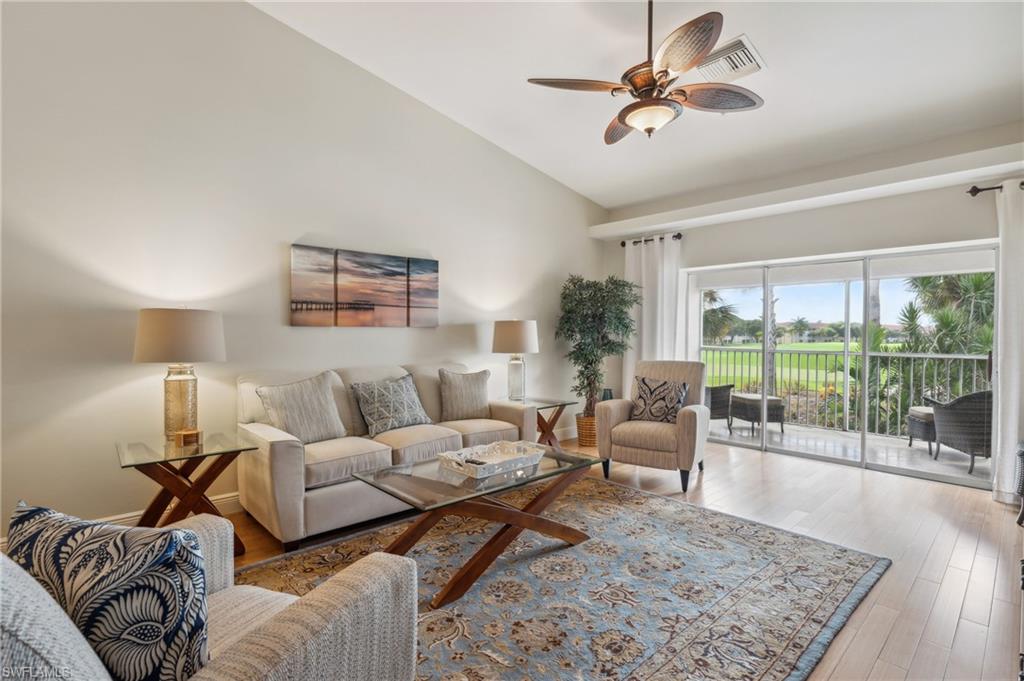 a living room with furniture a rug and a large window