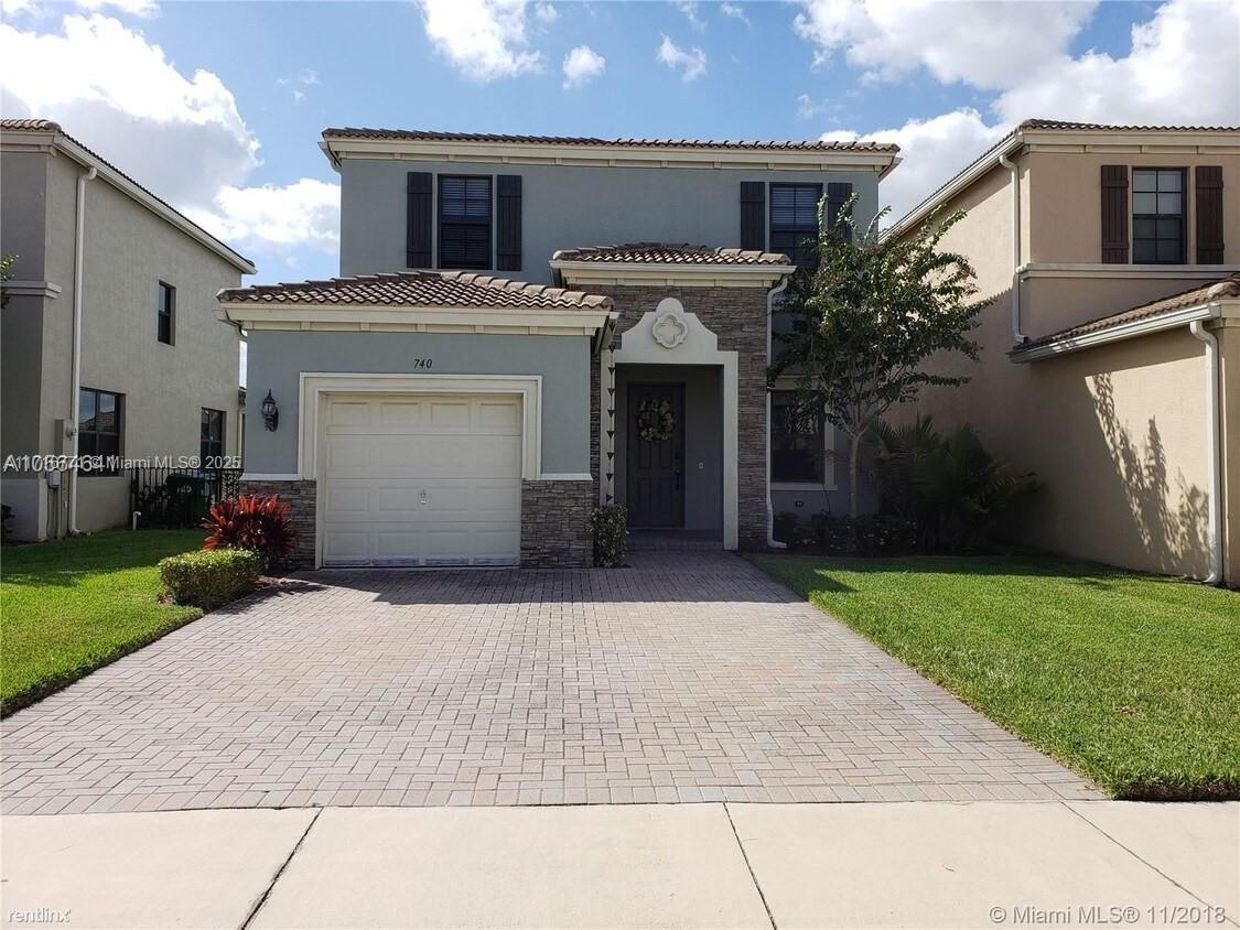 a view of a house with a yard and garage