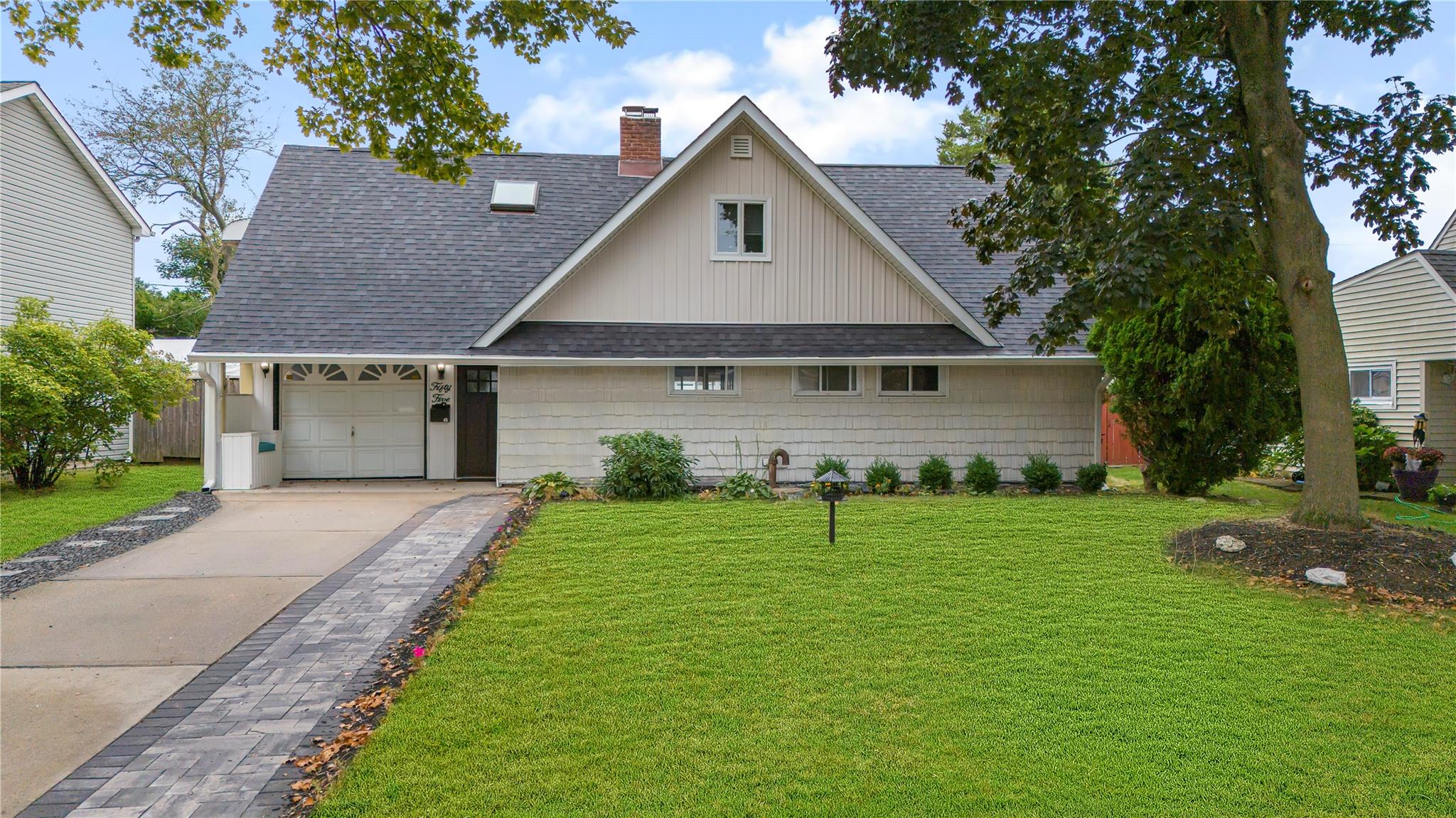 View of front of house featuring a front yard and a garage