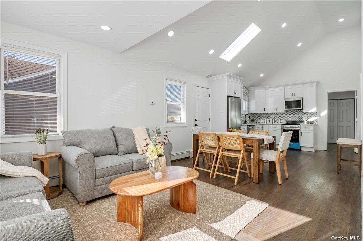 a living room with lots of furniture and kitchen view