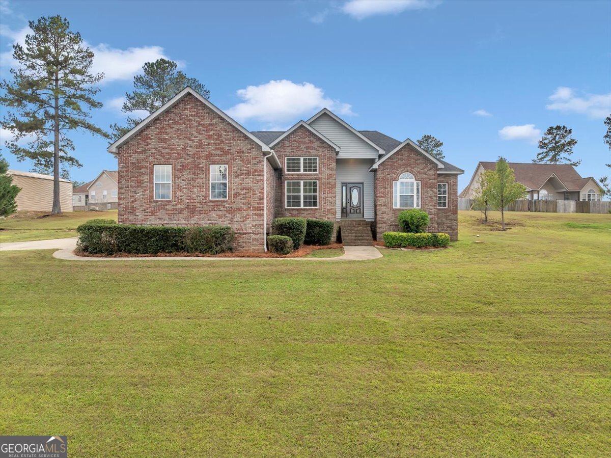 a front view of a house with a yard