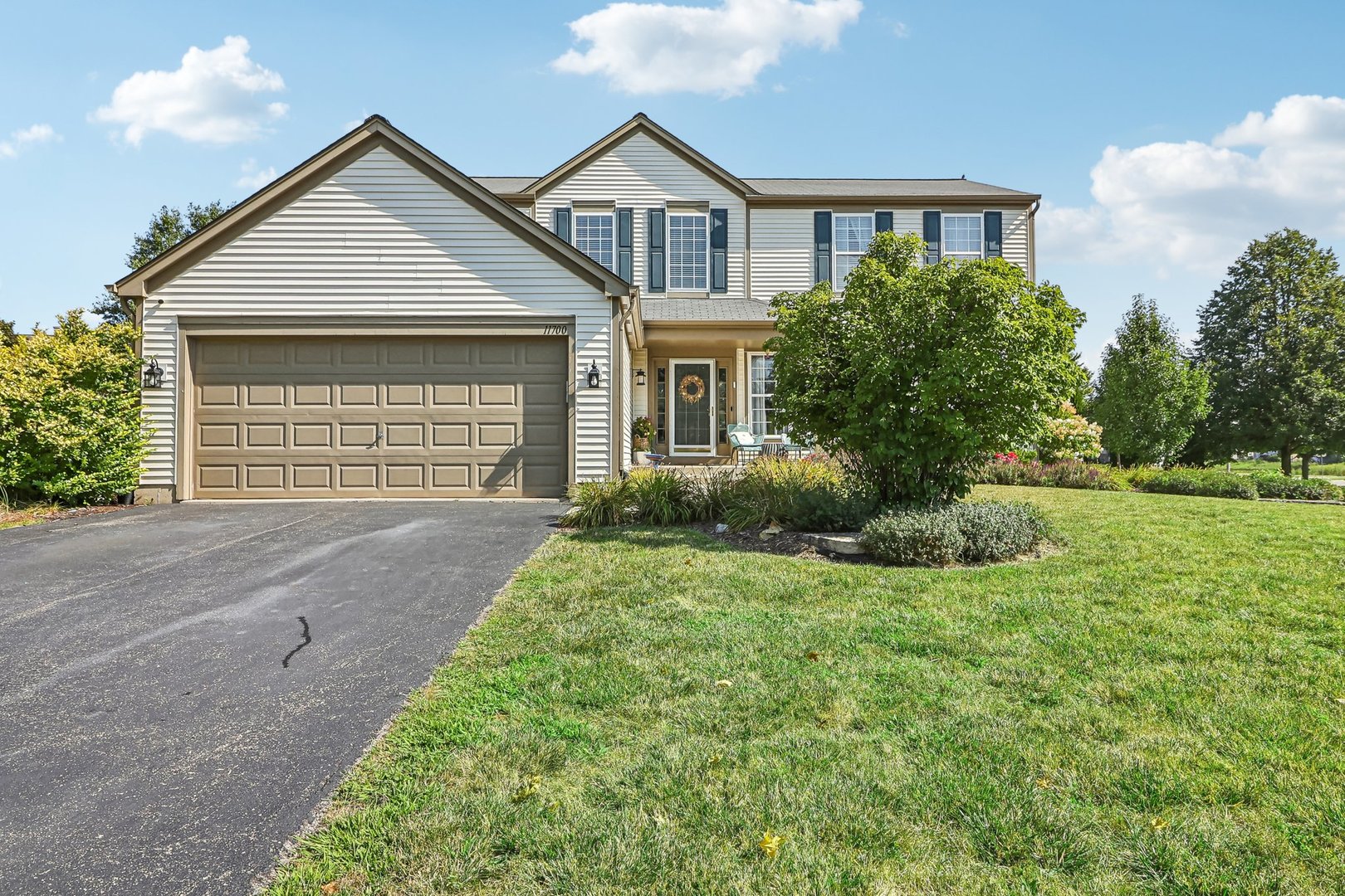 a front view of a house with a yard and garage