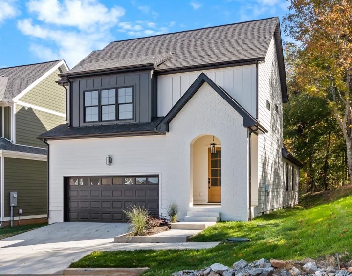 a front view of a house with yard and garage