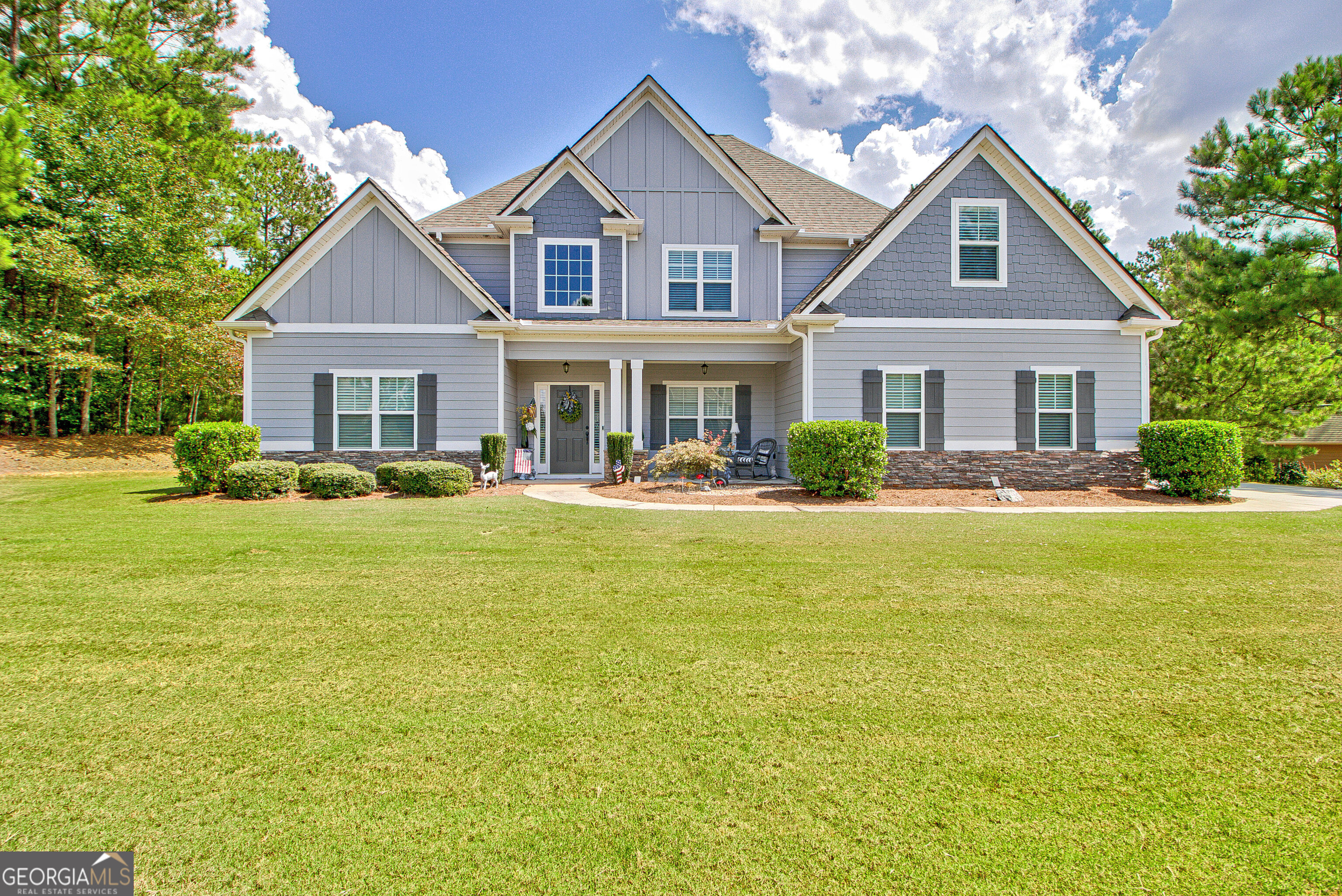 a front view of house with yard and green space