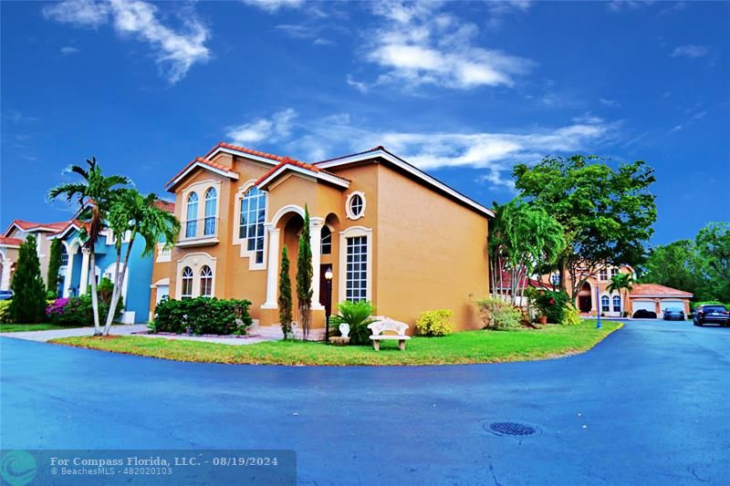 a front view of a house with garden