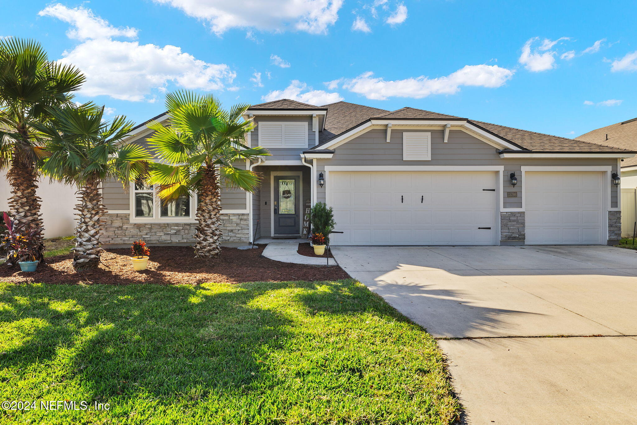 a front view of a house with a yard and garage