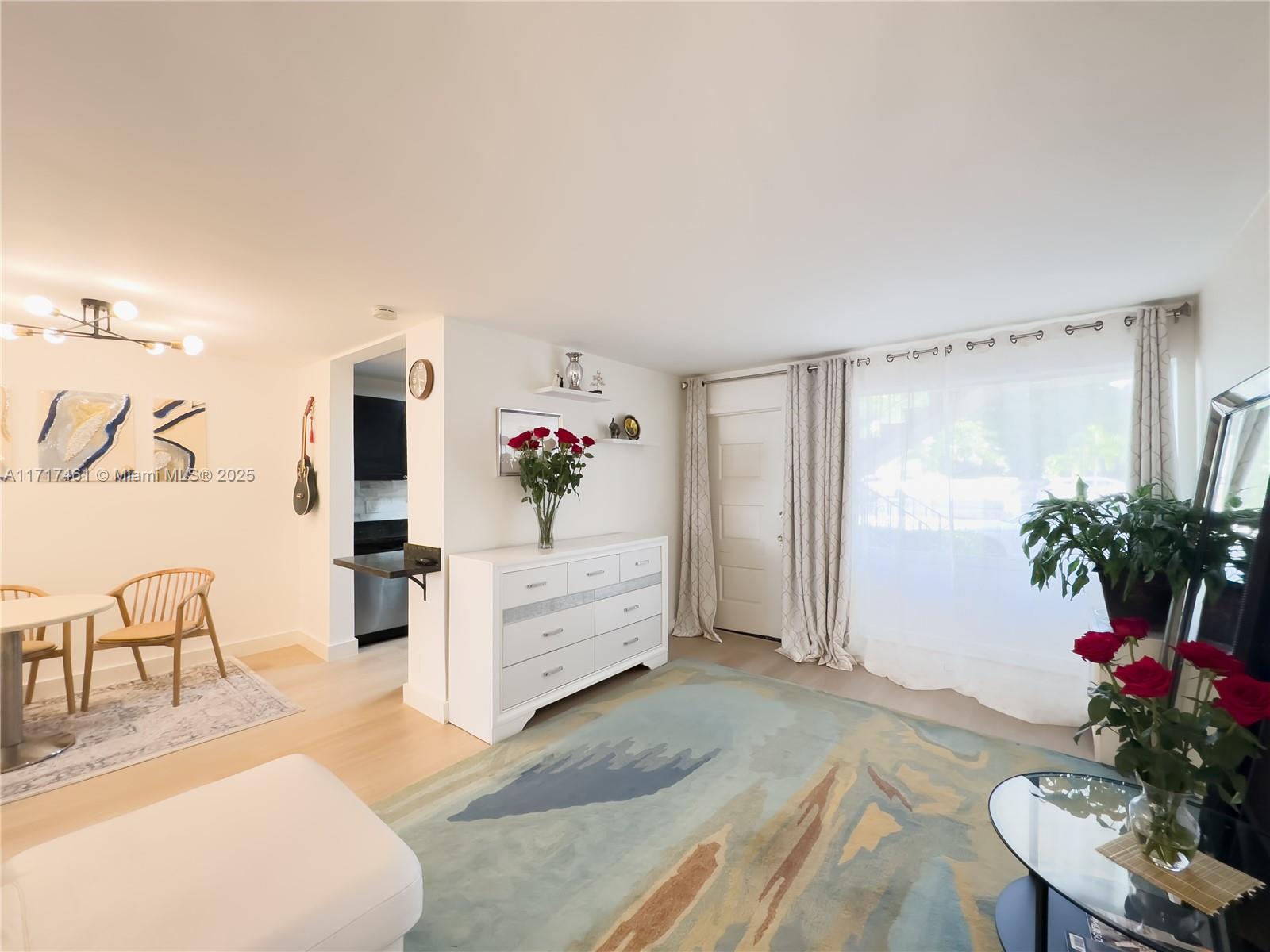 a living room with furniture and flowers