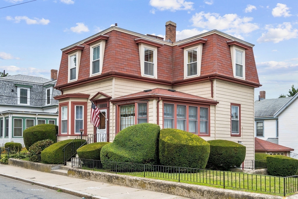 a front view of a house with a garden