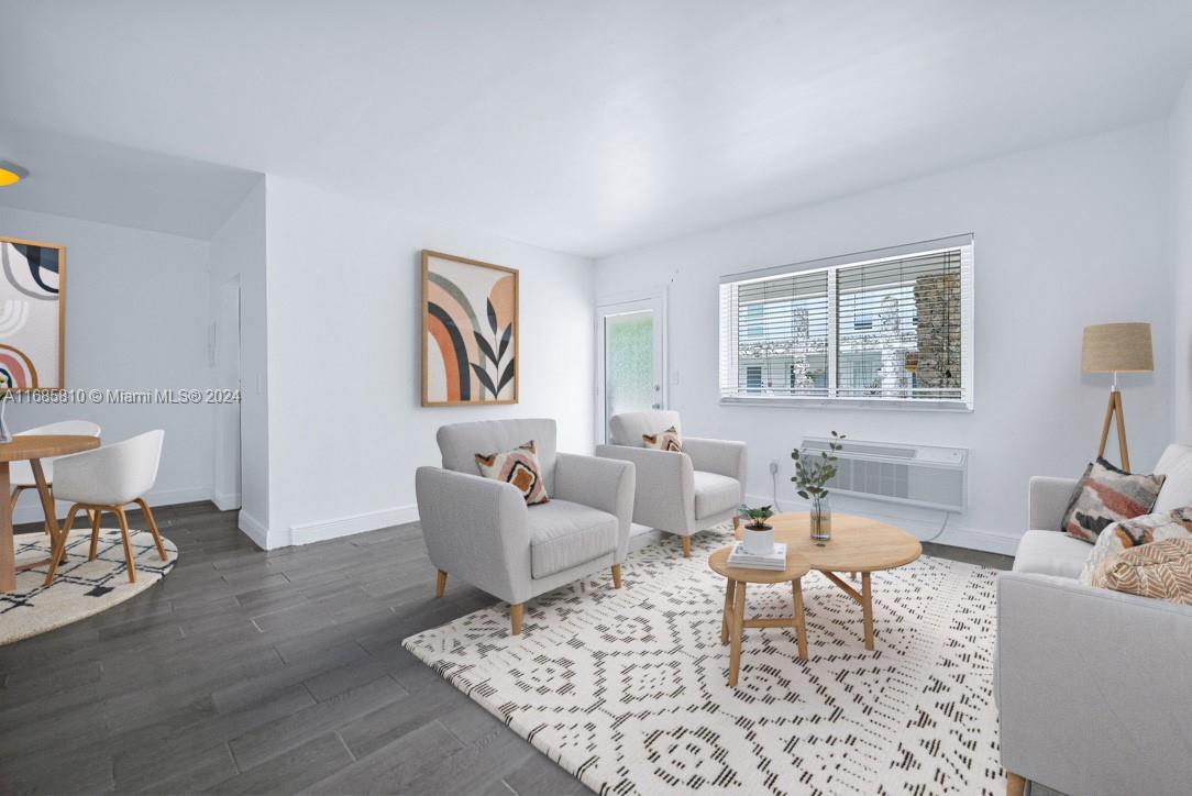 a living room with furniture a rug and a window