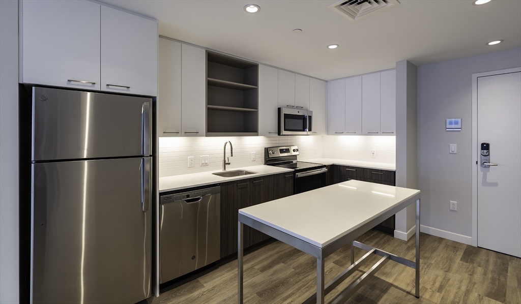 a kitchen with a refrigerator a sink and a stove