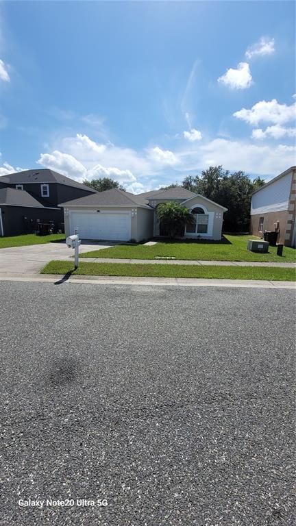 a view of a houses with a yard and a car parked