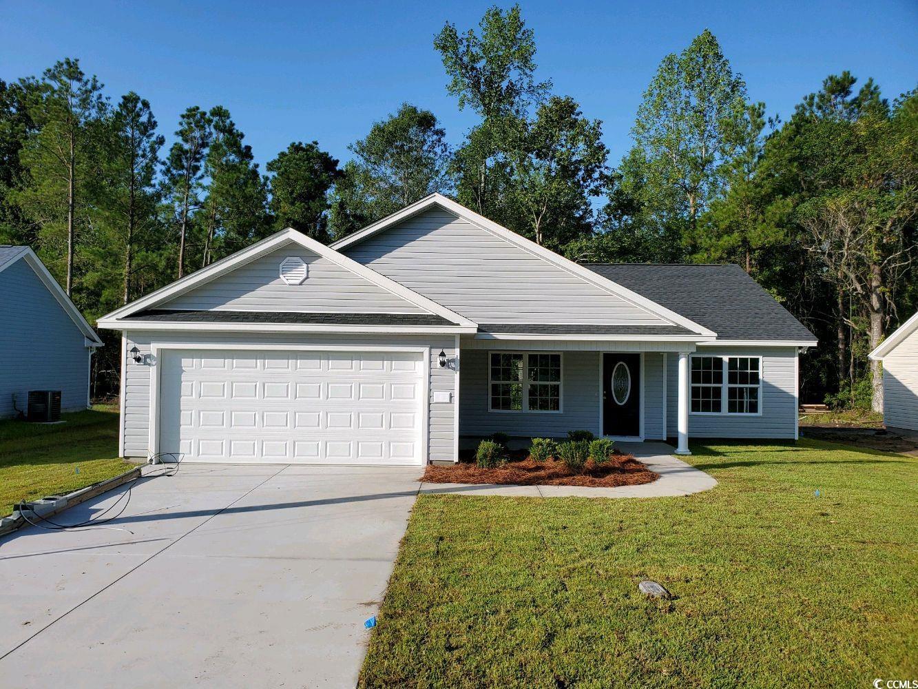 View of front of property with a garage, a front l