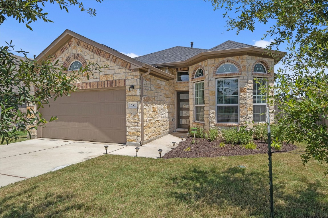 a front view of a house with garden