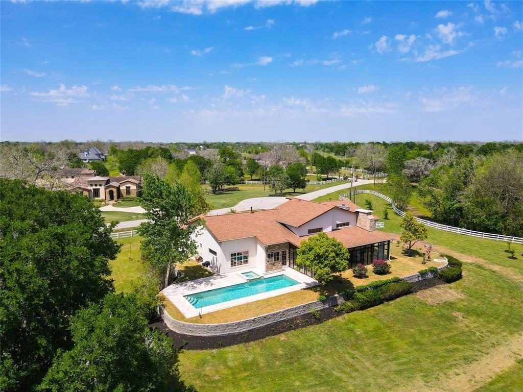 an aerial view of residential houses with outdoor space and swimming pool