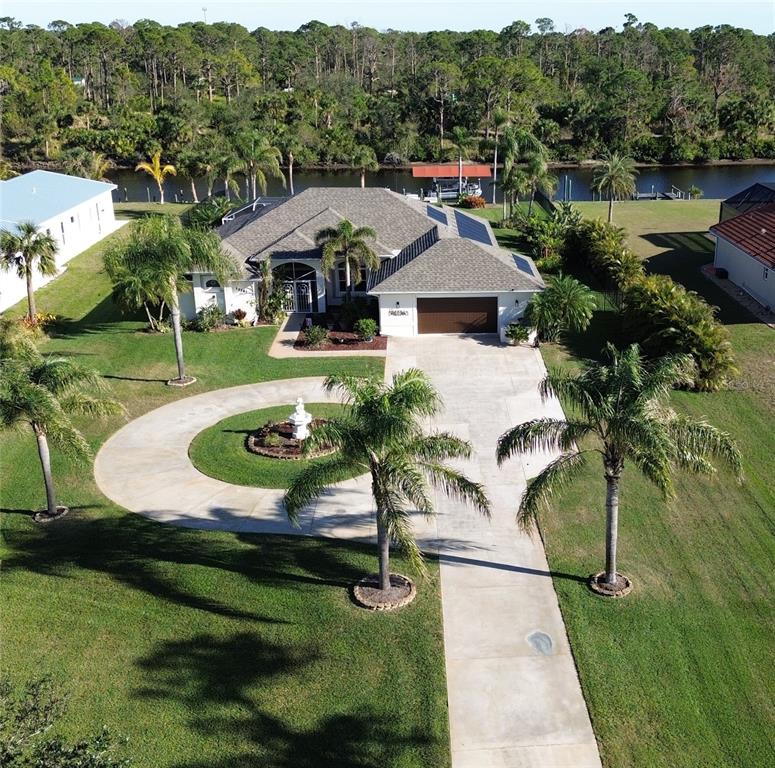 an aerial view of a house with garden space and lake view