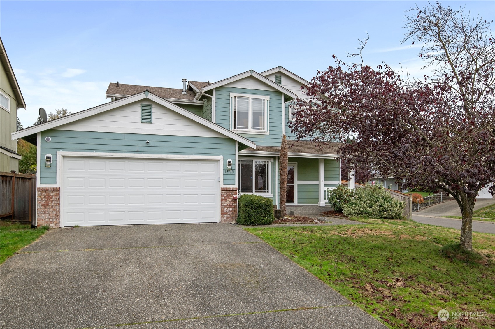 a front view of a house with a yard and garage