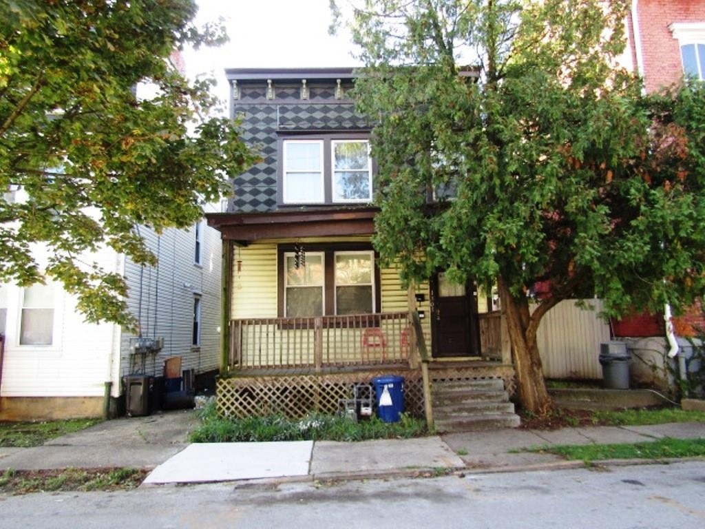 a front view of a house with a garden