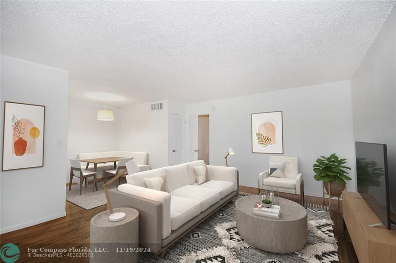 a living room with furniture and a potted plant