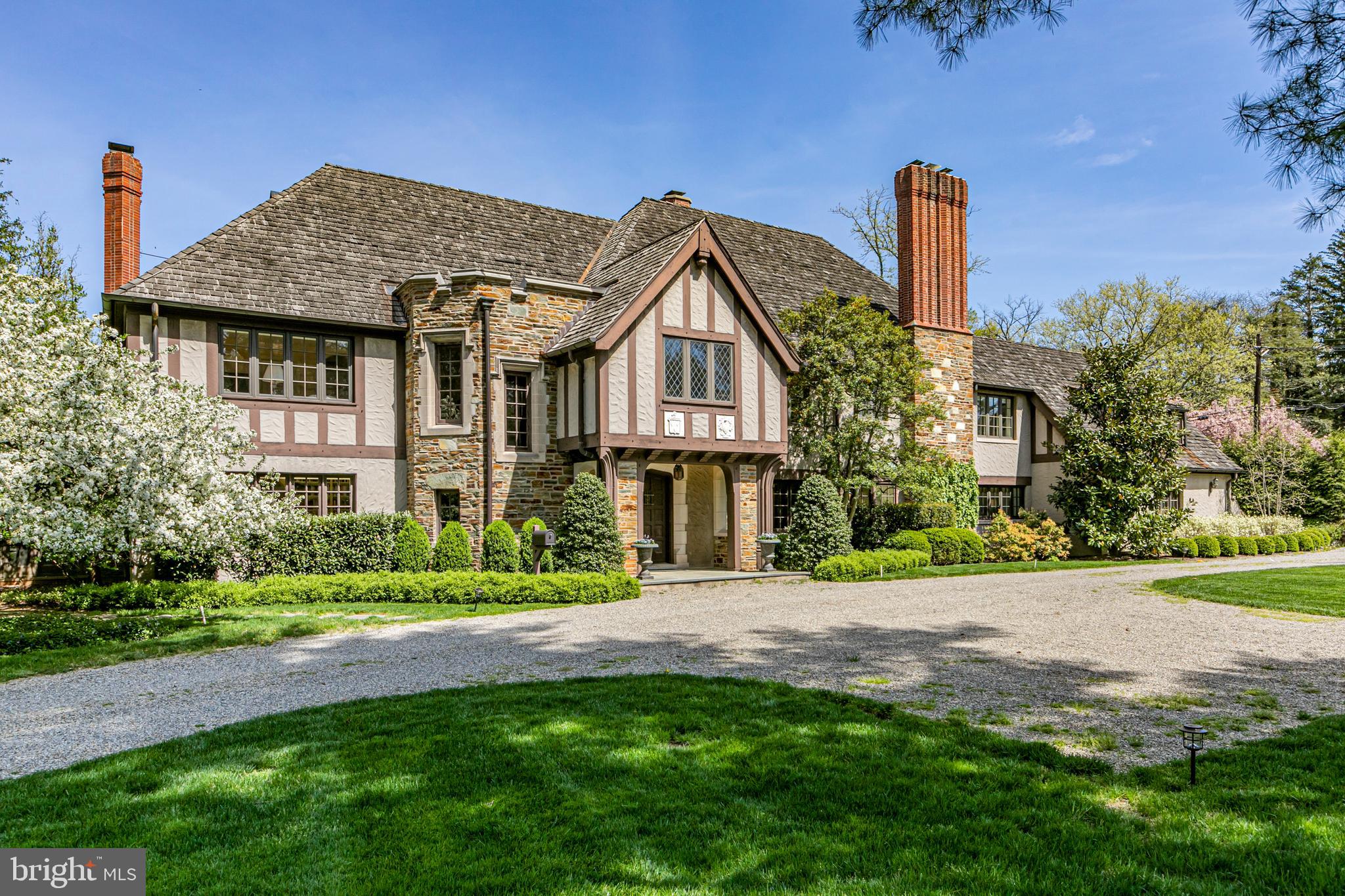 a front view of a house with a garden and plants