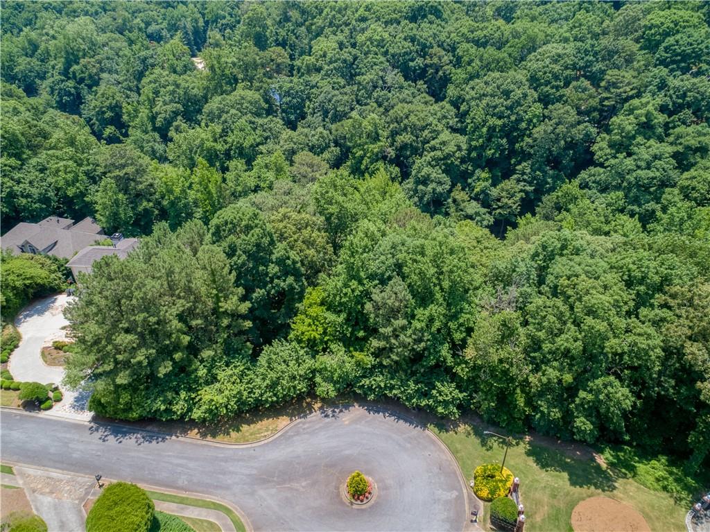 an aerial view of a backyard with swimming pool