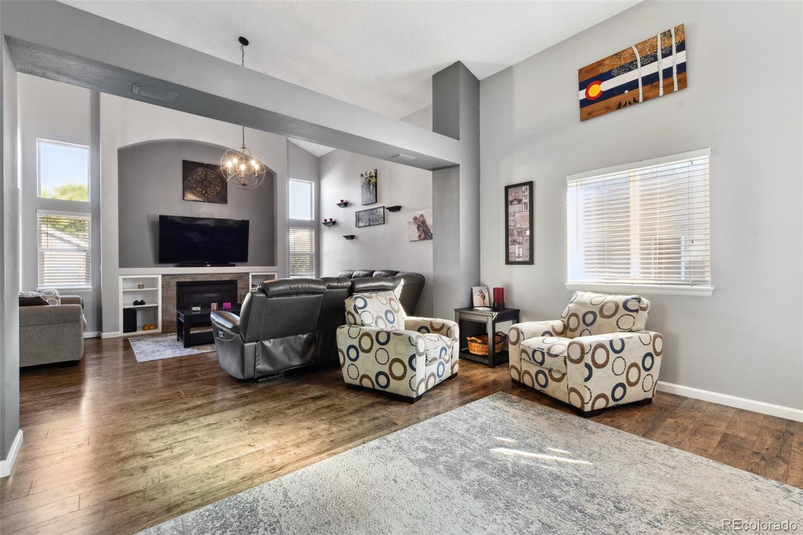 a living room with furniture window and flat screen tv