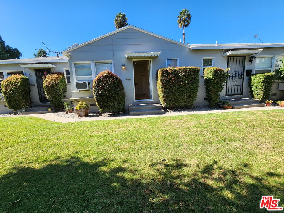 a view of a house with backyard and porch